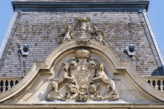 Rampant lions hold up the coat of arms of Festetics family on the tower of Festetics Palace,