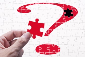 Question mark, human hand and puzzle game. concept of solve problem
