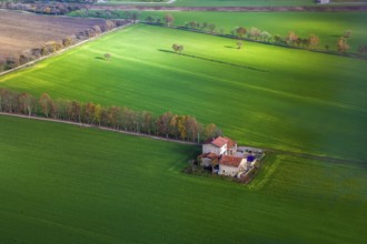 View on house and agricultural farm in Northern Italy, Several fields are green and another is