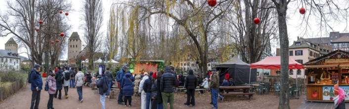 Panoramic photo Christmas market on the Louise-Weiss island square in the old town and the