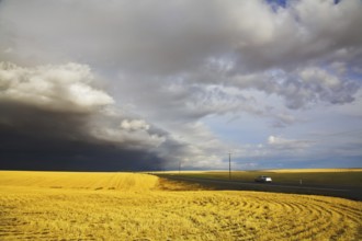 The car on highway among the fields, going aside thunder-storms
