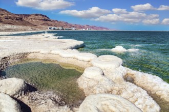 Evaporated salt forms crystals on the surface of the water. The saltiest lake in the world. Dead