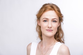 Portrait of a beautiful young woman of European, Caucasian nationality with long red hair and