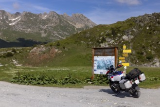 Signpost and information board, BMW R1300 GS Adventure motorbike on gravel road, Cormet d'Areches