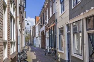 Street with historical houses in Delft downtown, Netherlands