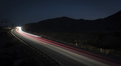 Light trails from cars moving fast late in the evening. Concept of high speed