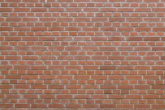 Bricks in an orange-red color in chain linked regulation to an old building in the Netherlands
