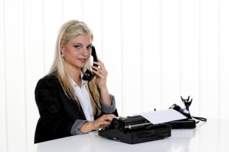 Young woman on the phone in the office. Austria