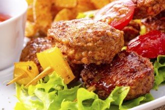 Meatballs skewers of tomato, paprika and baked potato quarters