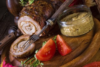 Rolling roasts fullly with dried fruit and bacon