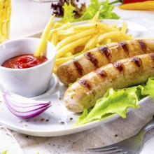Grilled bratwurst with chips and cold beer