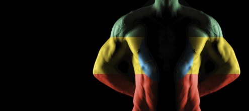 Ethiopia flag on muscled male torso with abs, black background