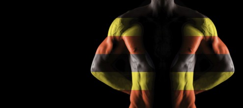 Uganda flag on muscled male torso with abs, black background