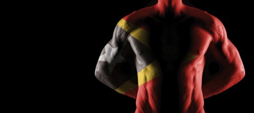East Timor flag on muscled male torso with abs, black background