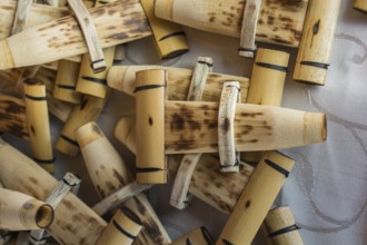 Dozens of handmade bamboo flutes in the view