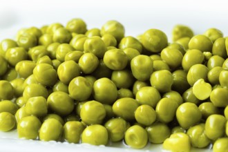 White bowl with canned green peas. Fermented food
