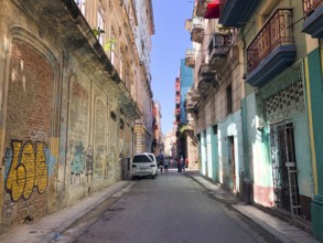 Street scene with colorful and old building on Havana. Urban scene with people and aged buildings