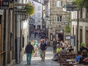 Tourists and locals stroll and dine on Raina Street (Rua da Raina), Santiago de Compostela,