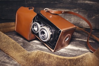 Vintage photo camera on a wooden surface