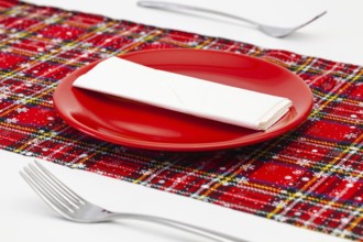 Red plate and Christmas decoration on the white wooden table.Top view. Flat Lay Image