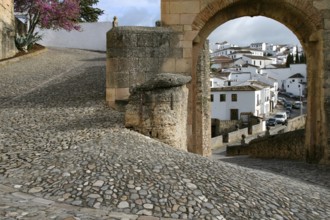 Narrow alleyway with cobblestones makes 180-degree turn in mountain village