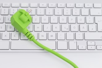Green power plugon a keyboard isolated on white background