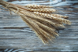 Bunch of rye ears on vintage wooden board