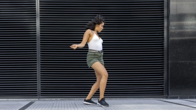Joyful dancer bringing life to the urban backdrop