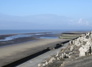 The cliffs area on the south promenade in Blackpool with the beach at low tide on a bright sunlit