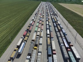 Long queue of trucks in the port at the terminal. Top view of the parking lot waiting for unloading