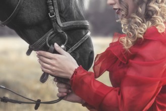 Love for animals. young Woman with no face dressed in an elegant vintage dress, gently cuddling a