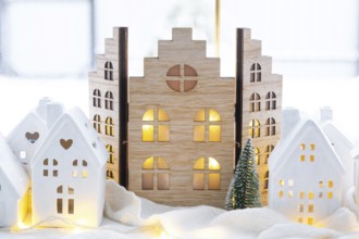 Cozy Christmas decor tiny house of small size on window sill with snow outside the window. Gift for