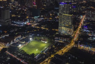 A picture of the EV Arena Kelab Sultan Sulaiman football field, and the Tamu Hotel and Suites Kuala