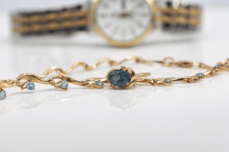 Accessories and jewelry for a fashionable girl : gold ring, necklace and original wristwatch