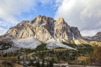 The majestic pass in the Eastern Alps of Falzarego. Picturesque sunset in the colorful rocks of the