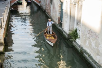 Man on a boat in Venice. Pass thru the channel