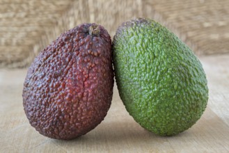 Green and red fruits on a wooden board