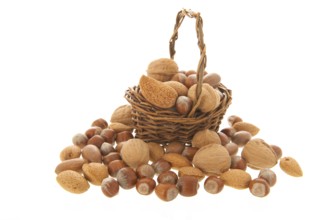 Assortment nuts in wicker basket isolated over white background