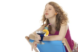 Younb blond woman with luxury cocktail at the beach
