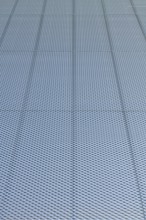 Closeup of metal mesh on concrete wall background texture