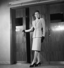 Women's fashion in the 1940s. A young woman in a typical 1940s outfit with a matching skirt and