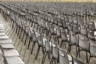 Aligned chairs prepared for an outdoor event