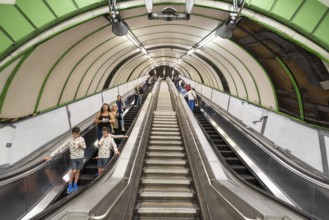 London, United Kingdom, May 12, 2019: View of escalators and travelers inside London Underground