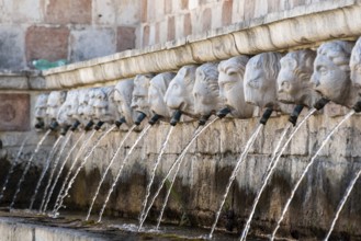 Famous mediaeval Fountain of 99 Spouts in ithe old town of L'Aquila, Abruzzi in Italy