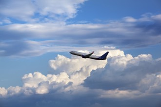 Modern passenger airliner flying in the cloudy sky