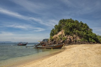 Tropical islands view with long tail boat ocean blue sea water and white sand beach at Koh Phak
