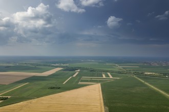 Aerial view of agricultural fields. Cloudy countryside, Aerial view