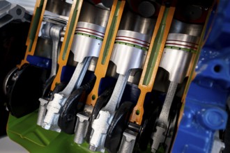 Car engine cut-through view. Four-cylinder straight-four engine piston engine sliced in half