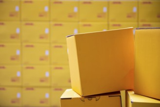 Yellow transportation boxes packages are seen arranged in a warehouse