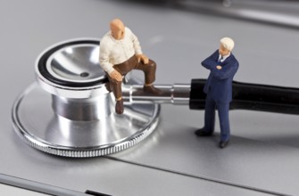 The photo shows two miniature figures in a counselling session
